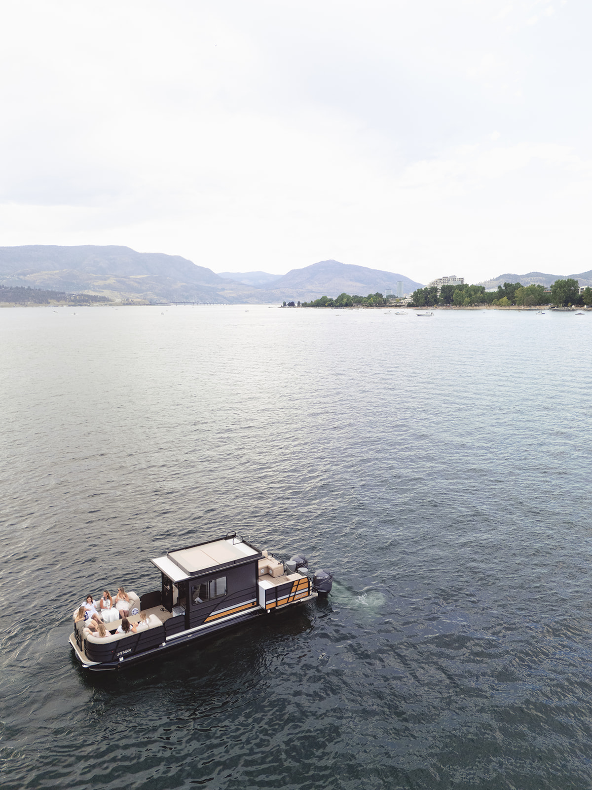 Aerial view of Baby Doll with the Kelowna shoreline behind.