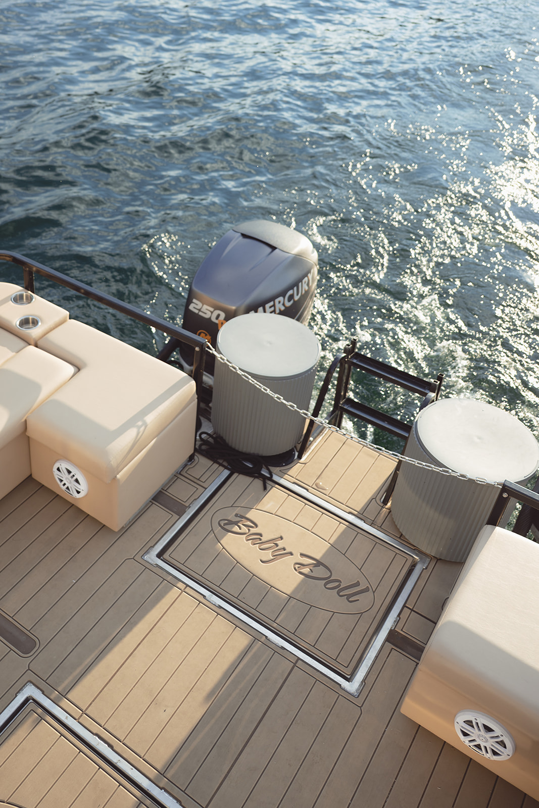 Baby Doll lettering on the aft deck beside the stern gate and outboard.