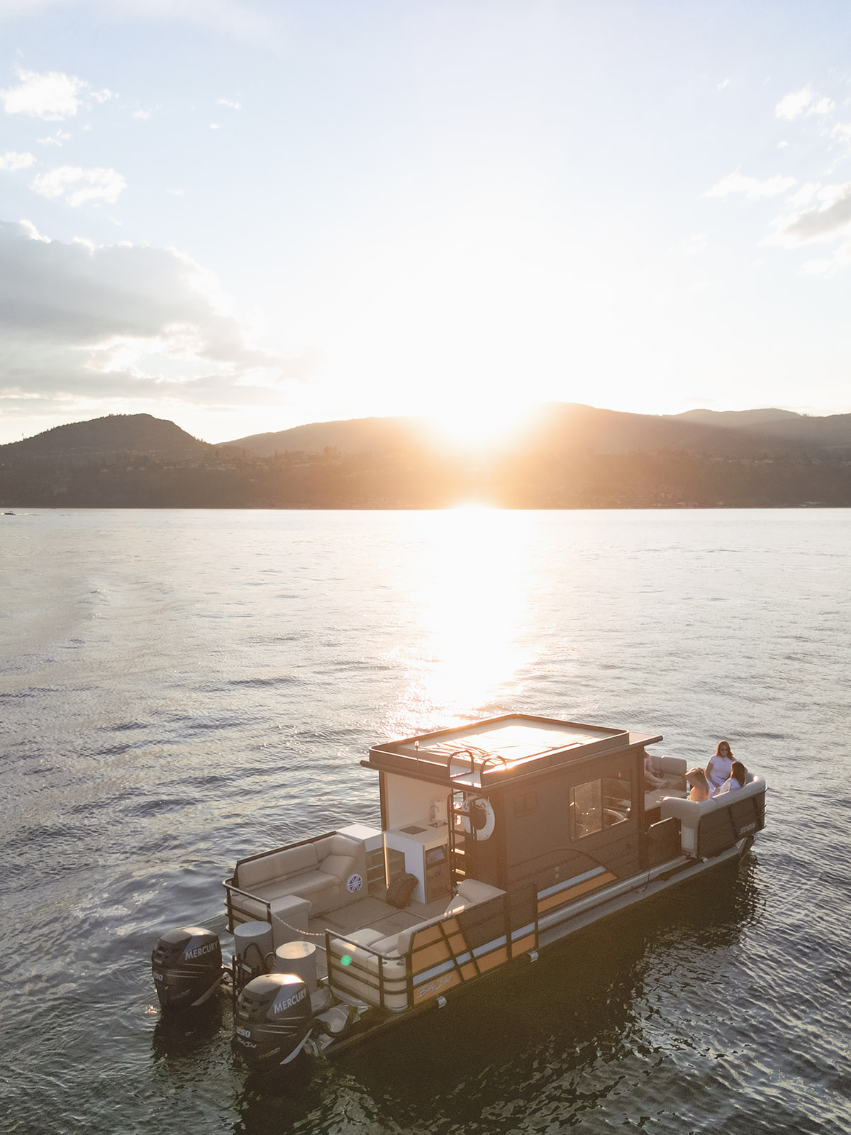 Aerial view of Baby Doll on Okanagan Lake at sunset.