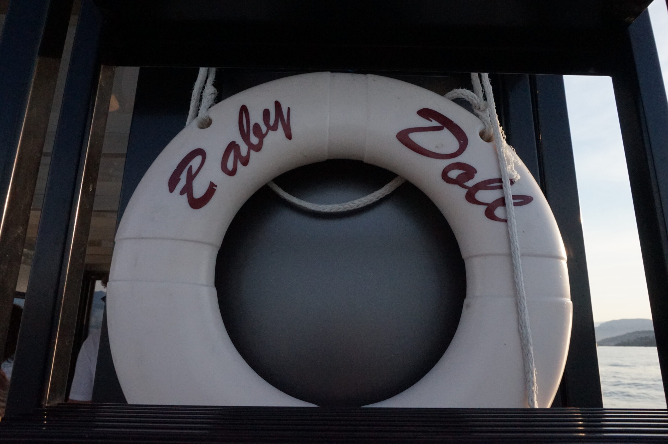 Close detail of the cream life ring with Baby Doll lettering.