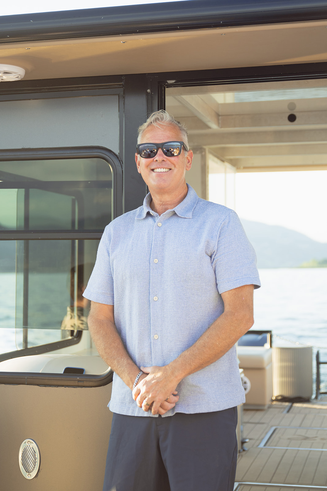 Captain Rick stands smiling beside Baby Doll’s cabin door.