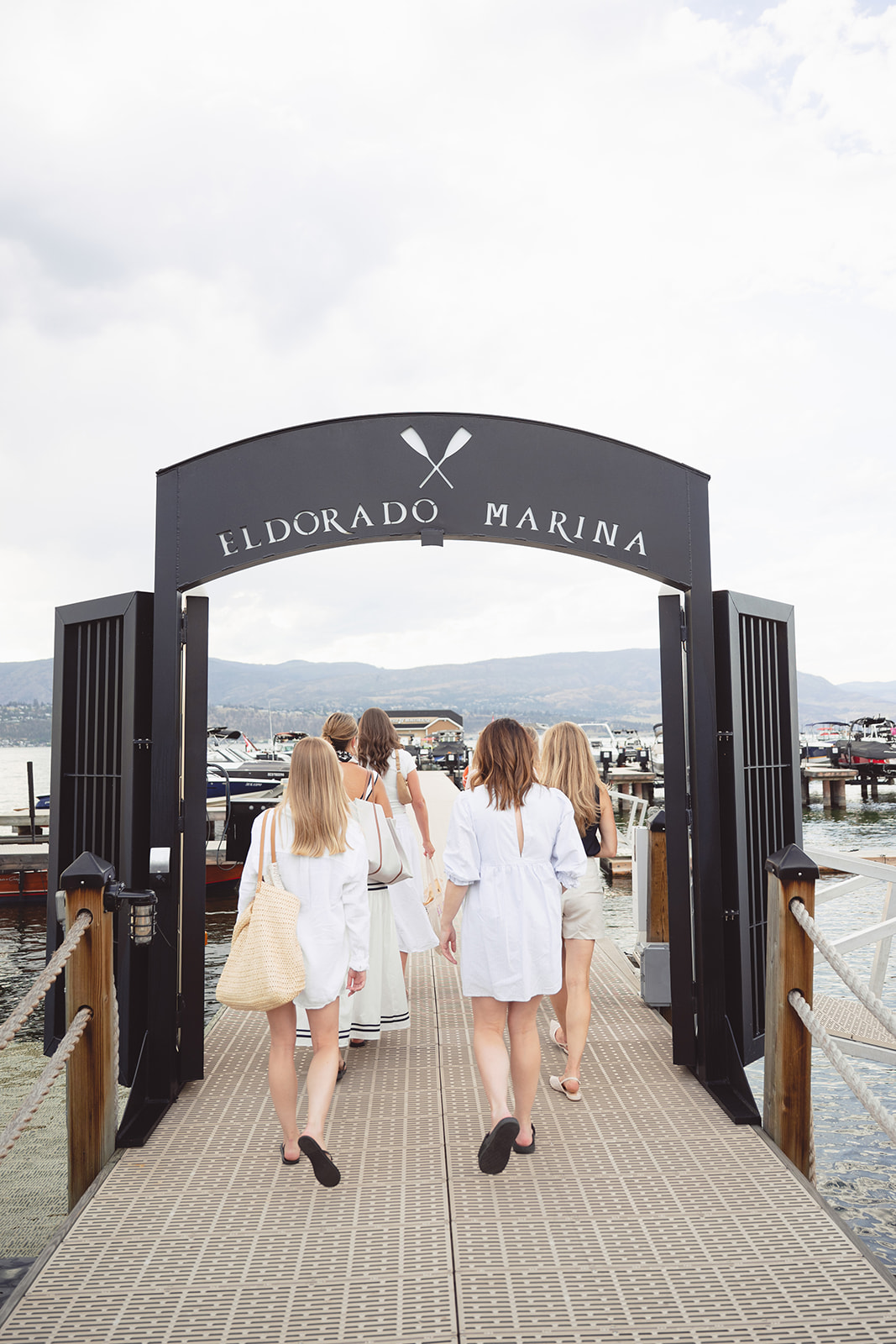 Guests walk beneath the Eldorado Marina arch, seen from behind.