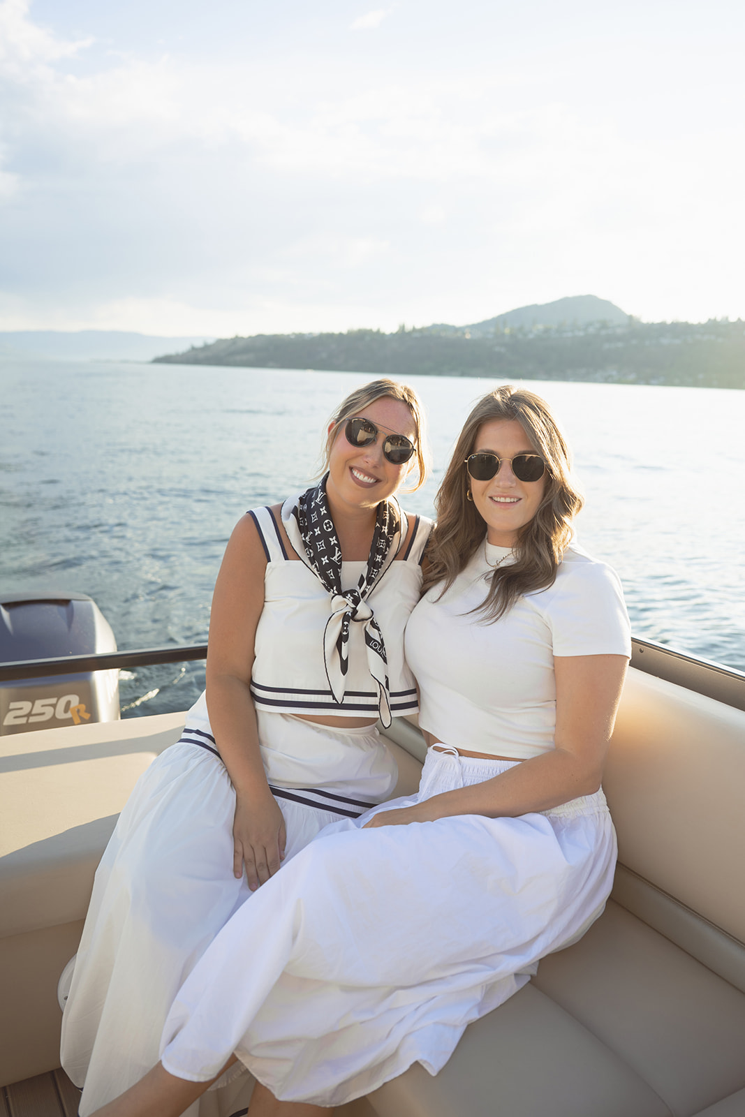 Two guests sit together on the aft bench.